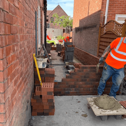 Bricklayer laying course — Essential Home Improvement
